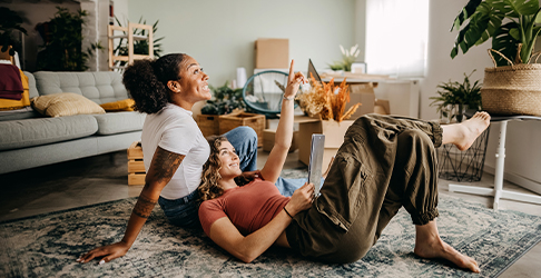 Couple sitting on rug in a modern home