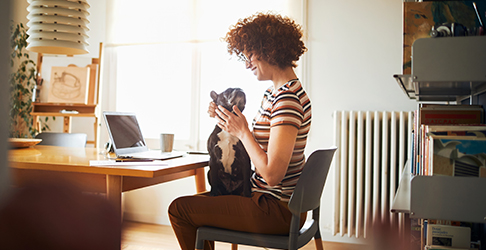 Woman Petting Dog at mobile work desk