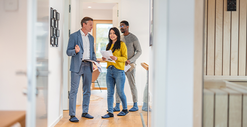 Couple walking through a house with a real estate agent